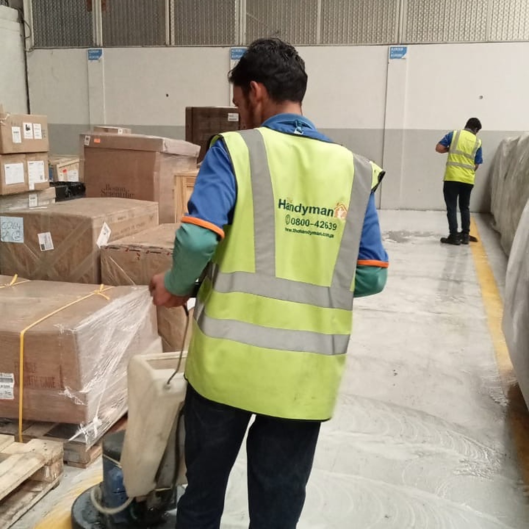 Janitorial Team operating a Floor Scrubber in a warehouse